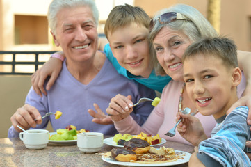 Grandparents with grandchildren at breakfast