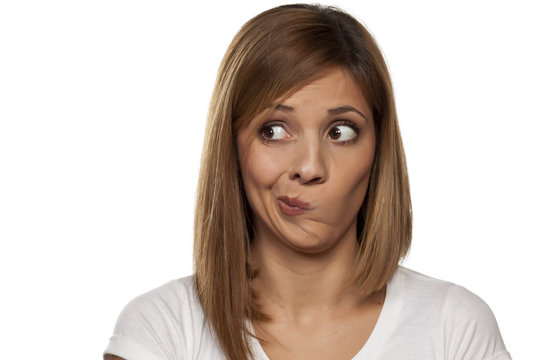 Thoughtful And Worried Young Woman On A White Background