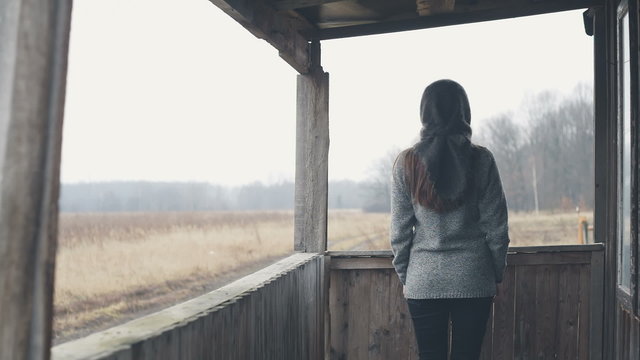 Women loneliness middle of autumn in the old field house. RAW video record.
