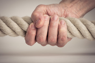 Hand holding strong rope