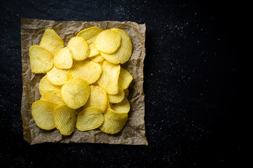 Potato chips on dark background