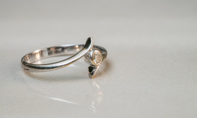 Closeup old diamond ring on blurred marble floor background
