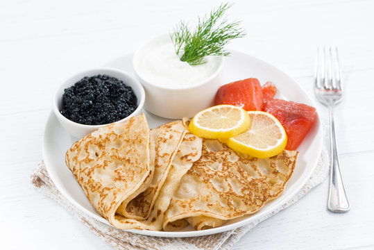 Traditional crepes with fish, sour cream and caviar