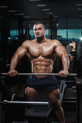 Fototapeta na wymiar Muscular athletic bodybuilder fitness model posing after exercises
