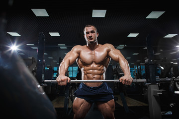 Fototapeta na wymiar Muscular athletic bodybuilder fitness model posing after exercises 