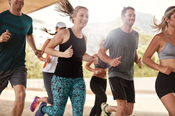 Happy young friends running together