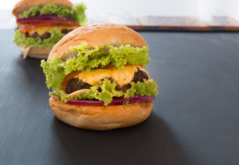 Closeup of home made burgers on black background