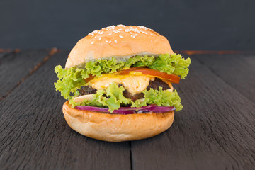 Closeup of home made burgers on black background