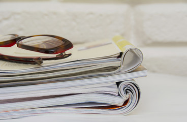 Stack of magazines on table, close up