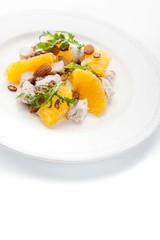Salad with chicken and orange on the white background vertical