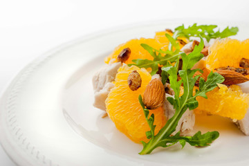 Salad with chicken and orange on the white plate horizontal