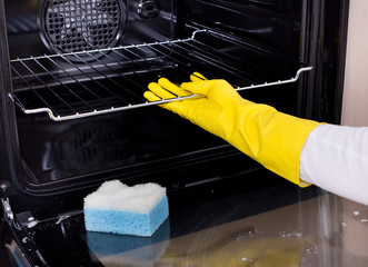 Woman cleaning oven
