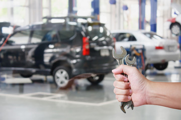Hand of professional Auto mechanic with wrench