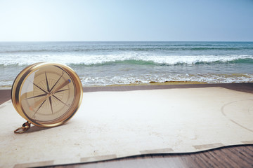 Old compass and map and ocean waves