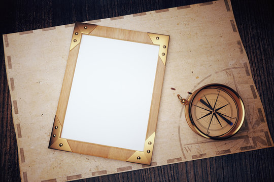 Top view of blank vintage picture frame on a wooden table with c