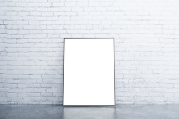 Blank white picture frame on concrete floor in empty room with w