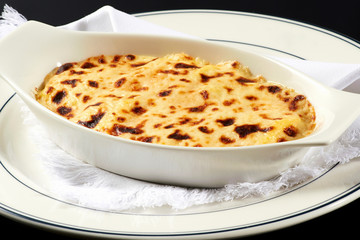Bowl of Italian lasagne with cheese topping