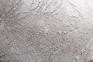 Closeup of female face with clay facial mask as texture or background