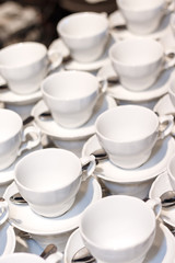 Many white cups for coffee and tea