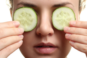 cucumber mask on the face of woman on white isolated background