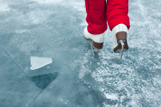 Young Woman Ice Skating Outdoors On A Pond On A Freezing Winter Day - Detail Of The Legs.
