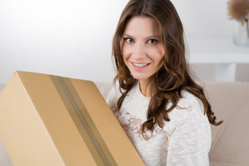 Woman unboxing her online order in the living room