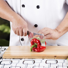 Chef cutting red bell pepper