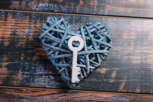 Blue Wicker Heart And A Key On Shabby Wooden Background