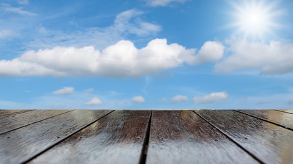 Fototapeta na wymiar Wooden table texture with blue sky background.