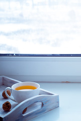 Cup of hot tea on the windowsill