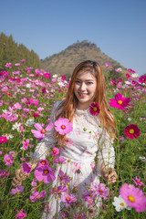 woman with cosmos flower field