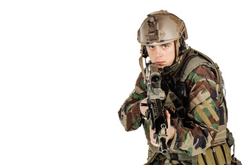 Fototapeta premium young ranger standing with a machine gun at white background
