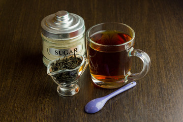 black tea cup and sugar bowl on the wooden table