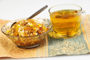 tea and jam-dried fruits, nuts with honey on tablecloth