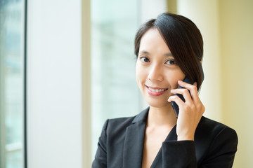 Businesswoman talk to cellphone at office