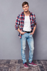 Full length portrait of handsome confident  man in checkered shirt