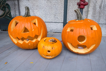 Jack o-lanterns by the door, during Halloween holiday.