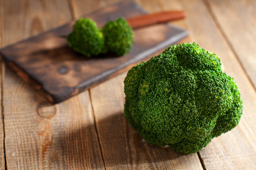 Raw green broccoli on wooden background