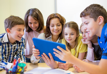 group of kids with teacher and tablet pc at school