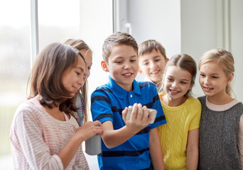 group of school kids with smartphone and soda cans