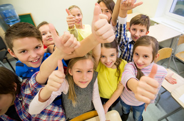 group of school kids showing thumbs up