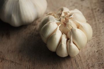 heap garlic on wood background