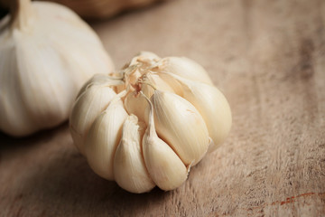 heap garlic on wood background