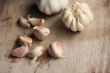 heap garlic on wood background