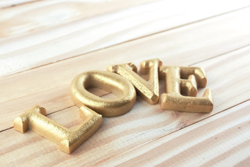 wood gold letter word love on wood background