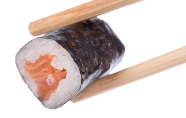 Sushi roll held by chopsticks