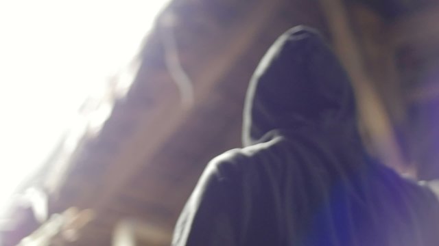Slow motion of vandal with mask backlight closeup