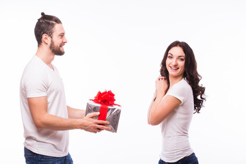 Valentine gift. Happy young couple with Valentine's Day present isolated on a white background....