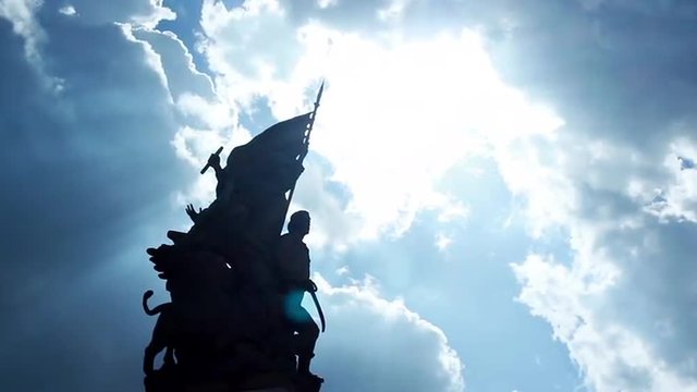 A beautiful shot of statue in Venice Square in Rome in cloudy day with shine sun's rays.