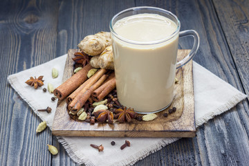 Masala chai with spices. Cinnamon stick, cardamom, ginger, clove, star anise, black pepper.